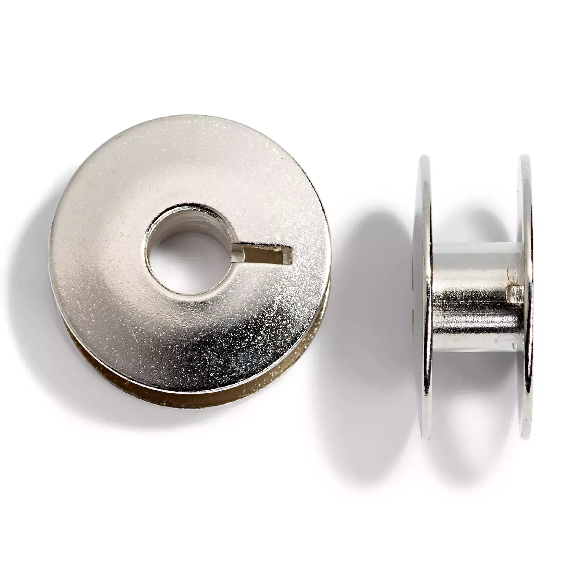 Metal sewing machine bobbins for rotary bobbin holders